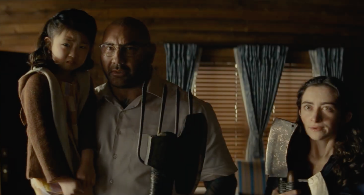 Leonard (Dave Bautista) carrying a terrified Wen (Kristen Cui) in Knock at the Cabin | Agents of Fandom