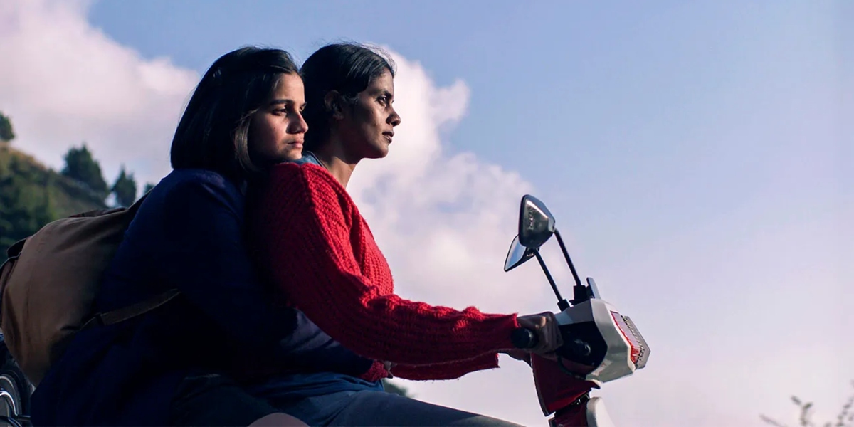 Preeti Panigrahi and Kani Kusruti riding a moped in Sundance Film Festival's Girls Will be Girls | Agents of Fandom