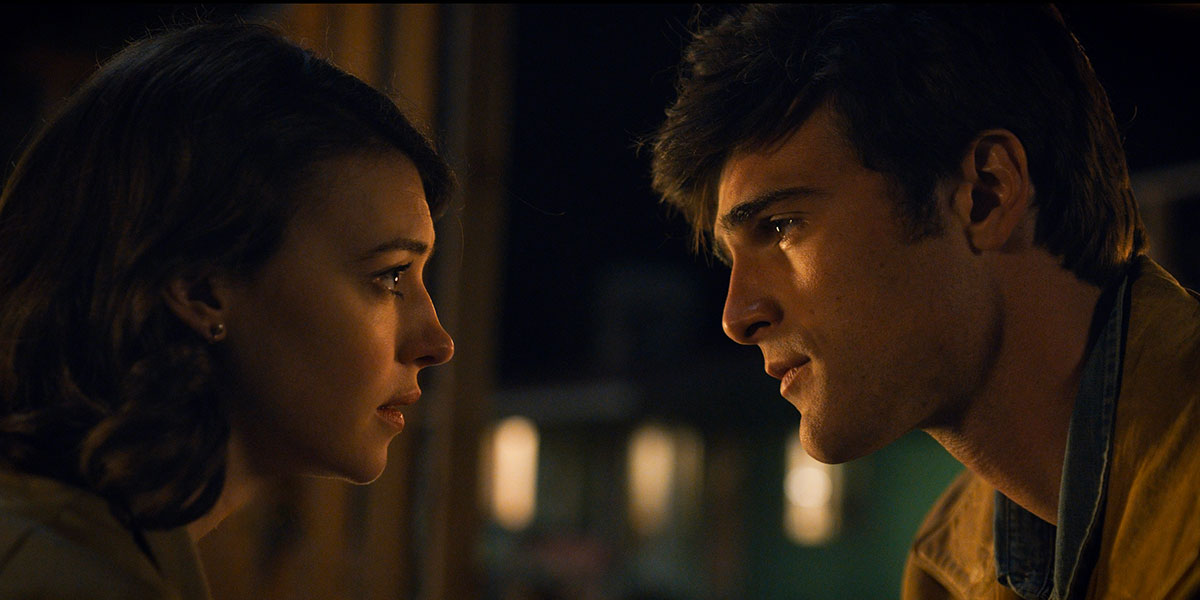 Daisy Edgar-Jones and Jacob Elordi staring at the each other in a moody, warm setting in On Swift Horses | Agents of Fandom