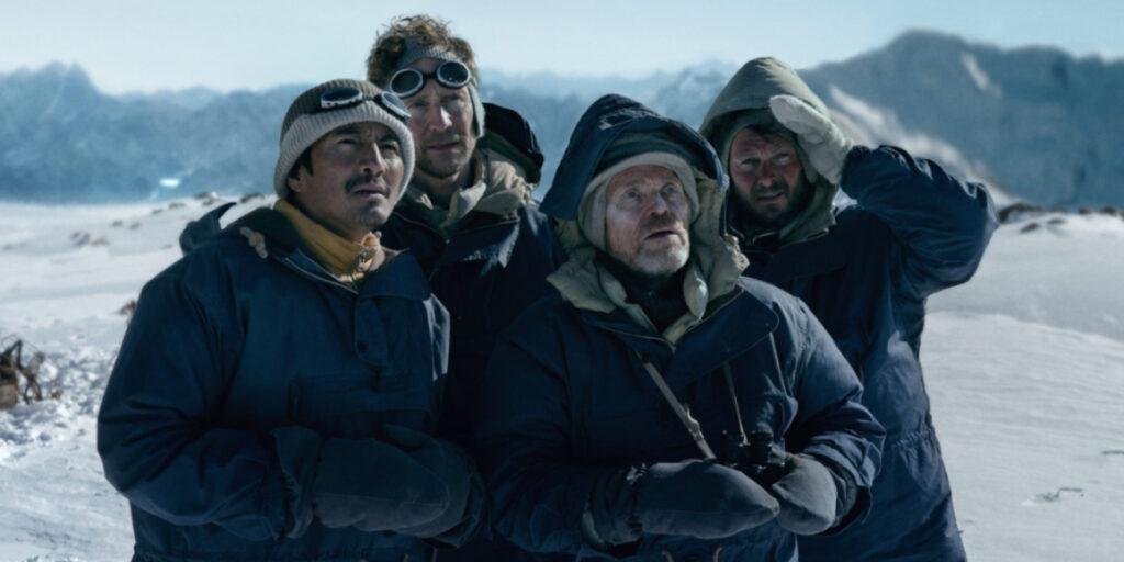 Genden Phuntsok, Tom Hiddleston, Willem Dafoe, and Benjamin Hoetjes looking at a mountain | Agents of Fandom