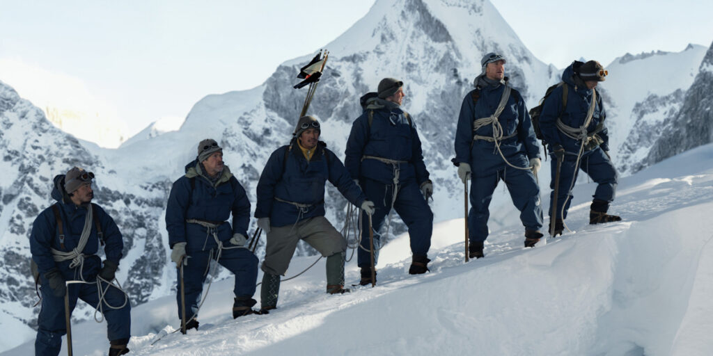 Tenzin Dalha, Willem Dafoe, Genden Phuntsok, Harry Greenwood, Tom Hiddleston, and Pasang Arya Sherpa climbing a snowy mountain | Agents of Fandom