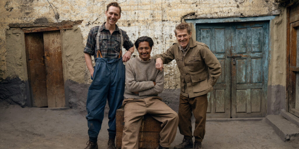 Tom Hiddleston, Genden Phuntsok, and Willem Dafoe smiling for a photo | Agents of Fandom